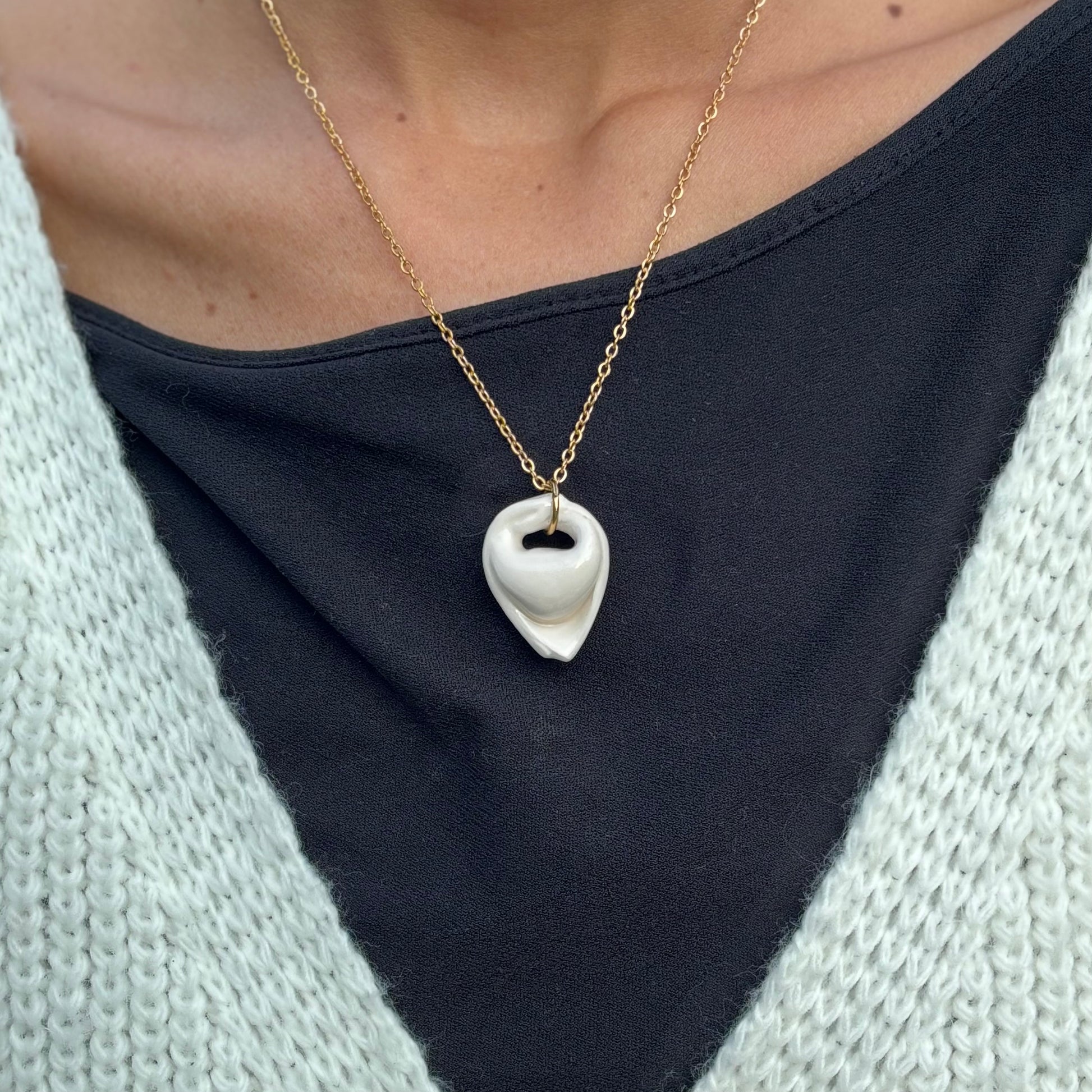 Handcrafted white ceramic tortellino pendant on a gold stainless steel chain banceramiche 