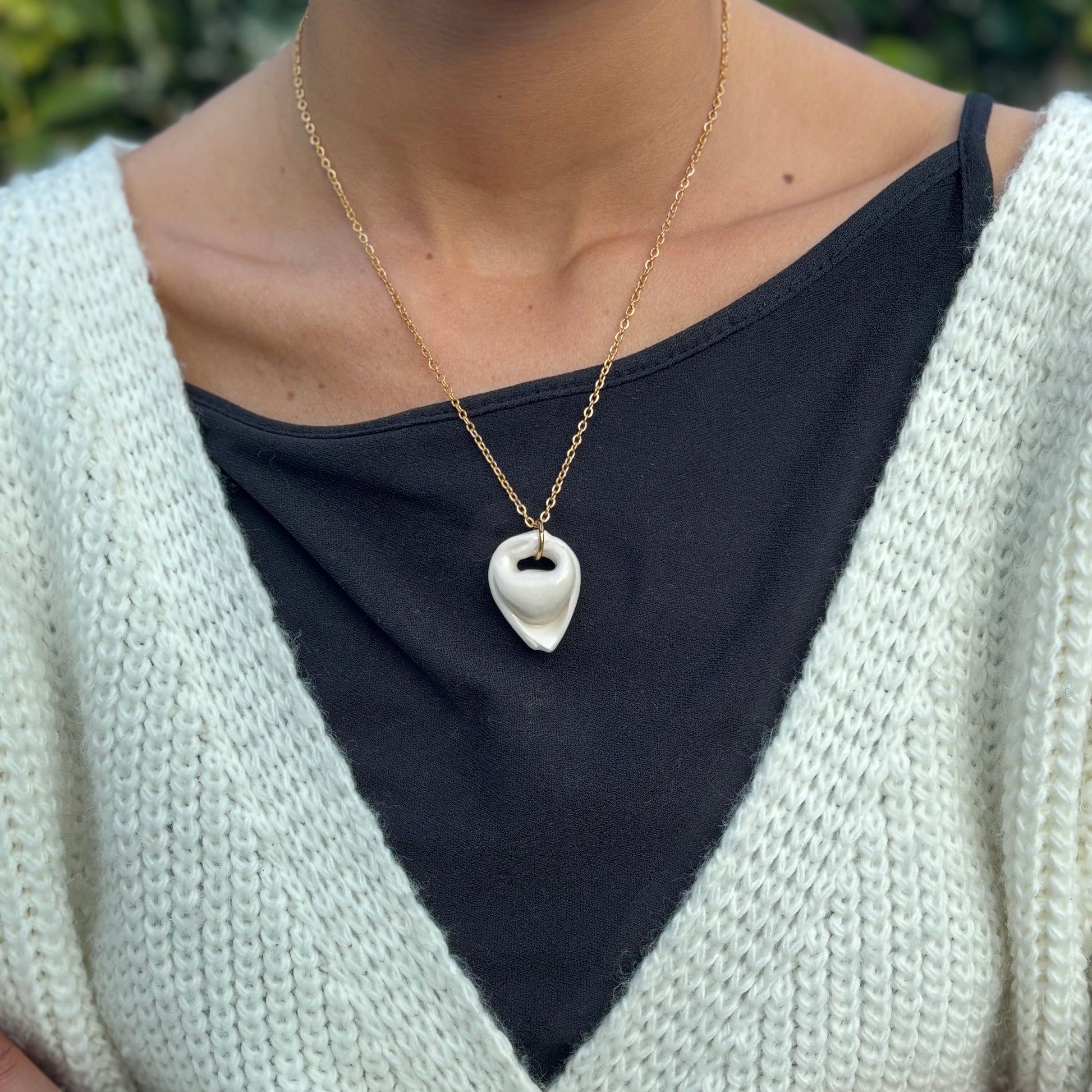 Handcrafted white ceramic tortellino pendant on a gold stainless steel chain banceramiche 